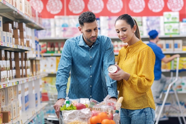 Image Man and woman checking the nutritin label in a supermarket.