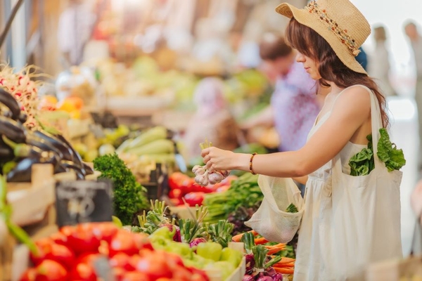 Image A young lady shopping at a farmer's market.