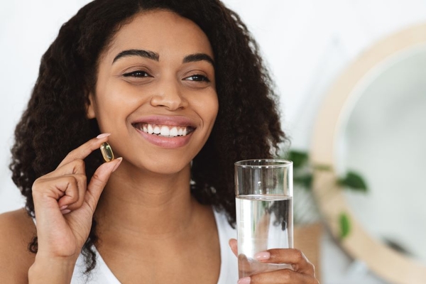 Image woman takes supplement