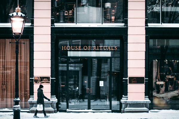 Man walking in front of Rituals store in Amsterdam.