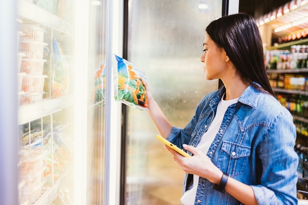Image A shopper buying plant-based burgers.