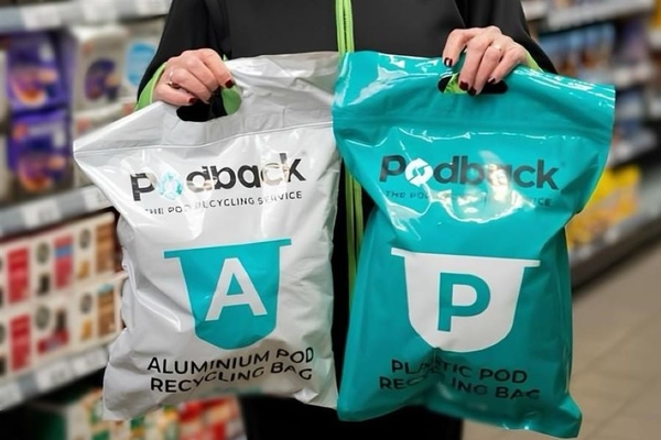 Image A person holding two plastic bags.
