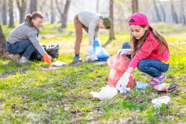 A kid picking up trash.