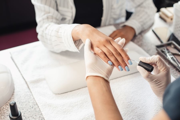 Image A woman getting a manicure.