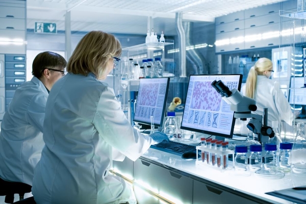 Three scientists sitting in a lab.