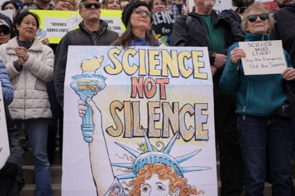 Woman holds sign supporting science in rally