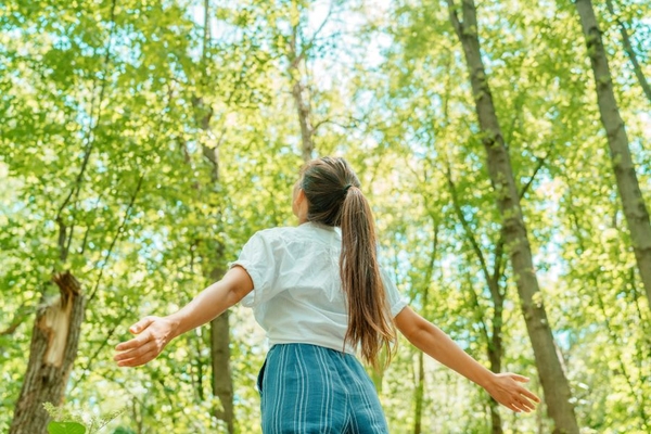 Image woman in forest breathes in