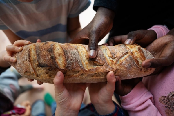 children hold one piece of bread