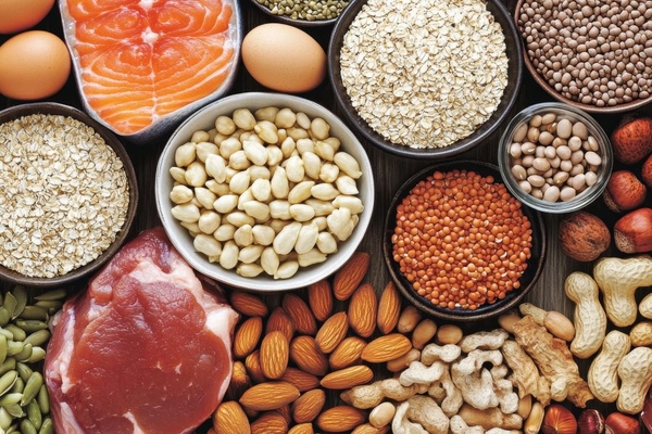 Image meat, eggs, salmon, nuts, legumes spread out