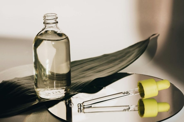 Image bottle of jojoba oil with pipette