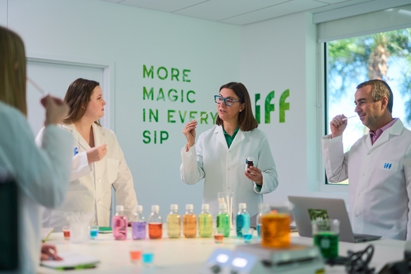 scientists in lab coats working with colorful oils in the lab
