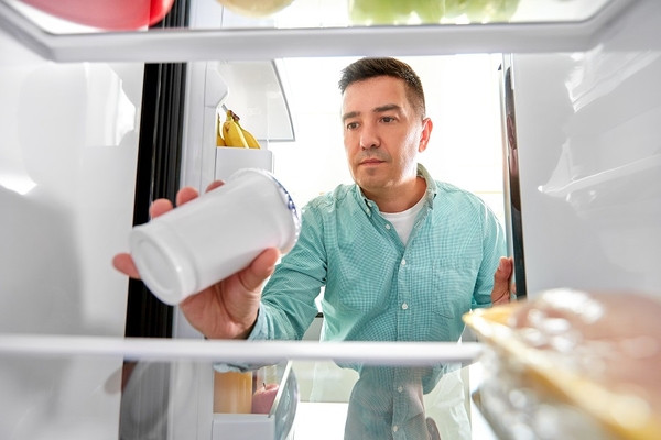 Image A consumer storing food in a fridge.