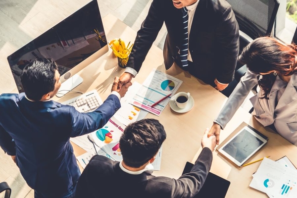 Business people shaking hands to celebrate deal