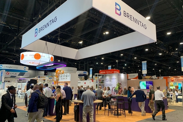 Image trade show booth with people walking around