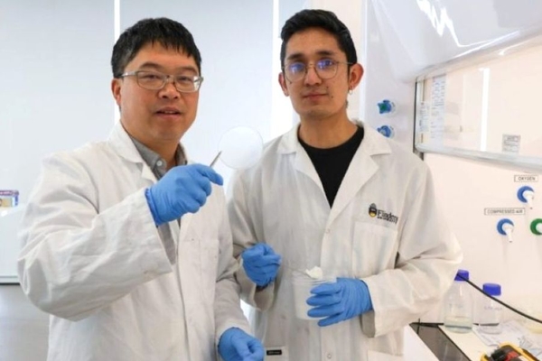 Men wearing gloves holding a piece of film