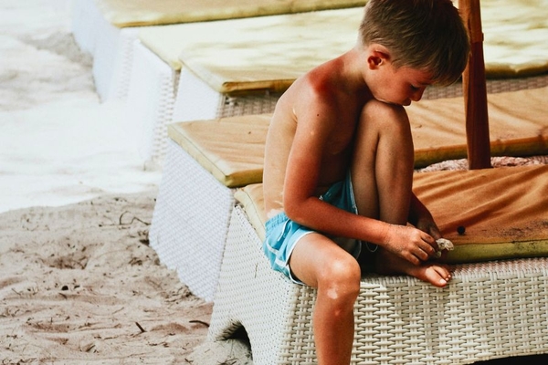 Image boy on the beach sitting