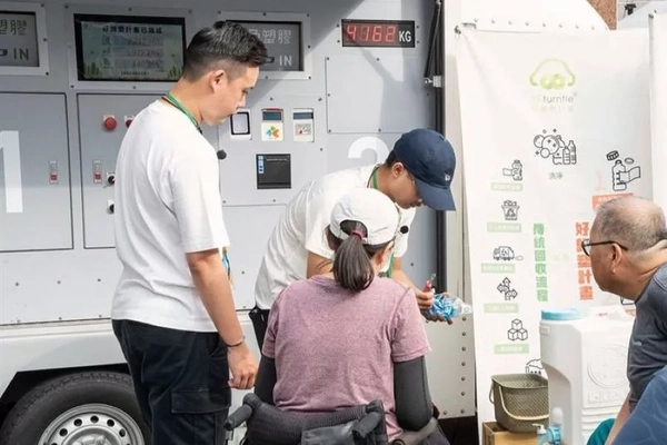 Image A group of people standing next to a machine