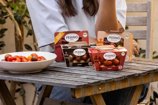 Image A person sitting at a table with food on it.
