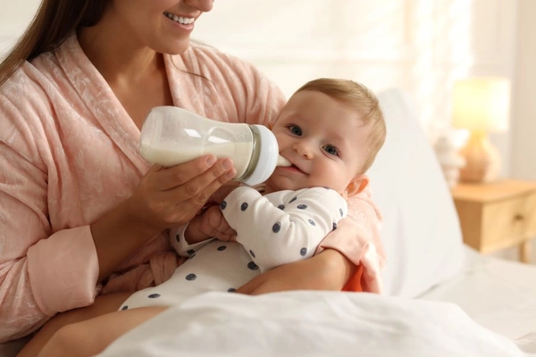 Image Mother feeding baby formula