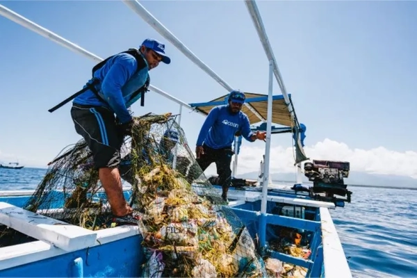 Image men hauling plastic waste from ocean on boat