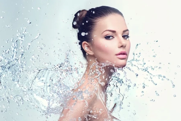 Image A woman posing with water thrown over her.