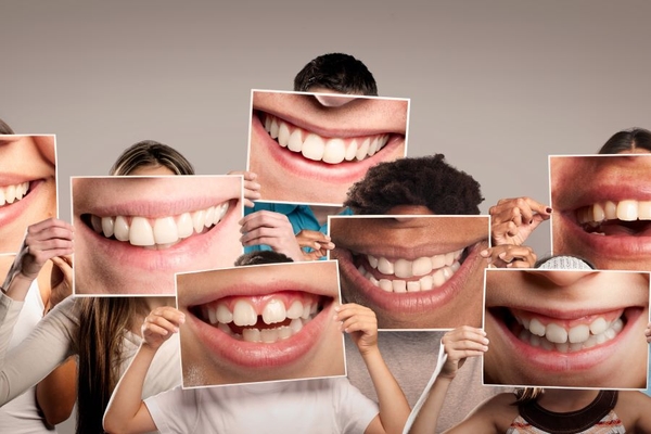 Image people holding photos of large smiles