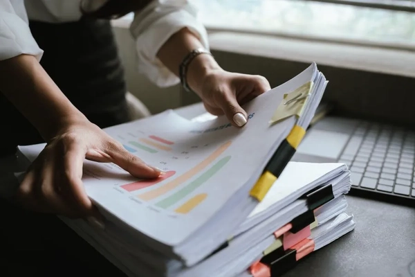 Hands holding documents.