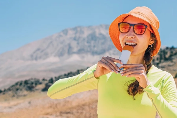 Asian woman eating protein bar