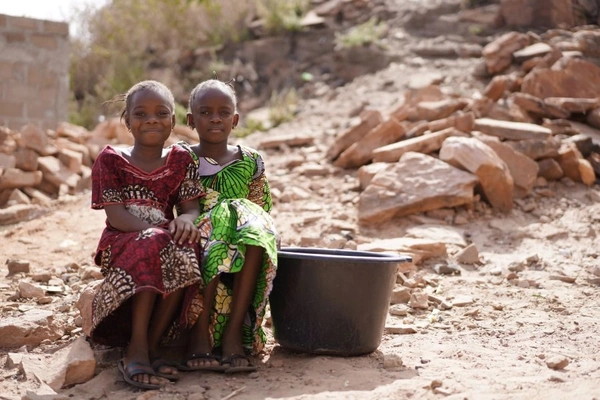 Image Two girls collecting water