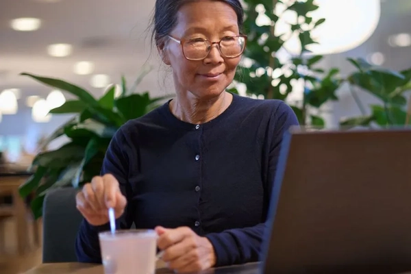 Image Senior woman stirring a protein medical drink