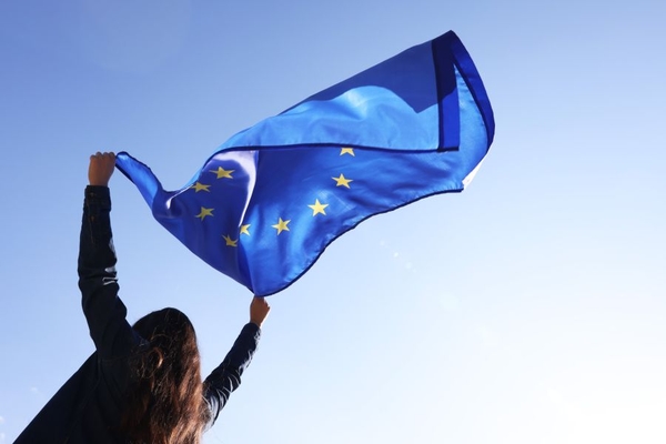 A girl holding an EU flag.