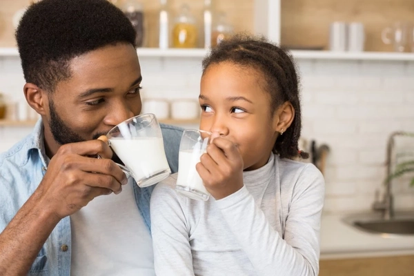 Image Father and daughter drinking milk.