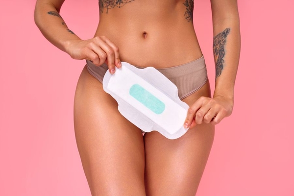 Image person holds pad in front of crotch