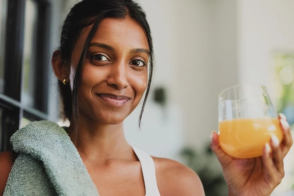 Smiling woman taking supplements Smiling woman taking supplements