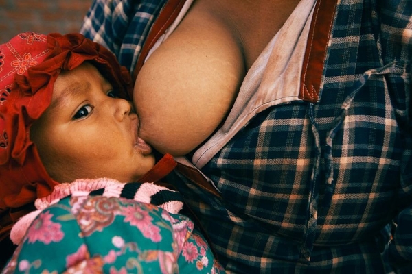 Image woman breastfeeds her baby