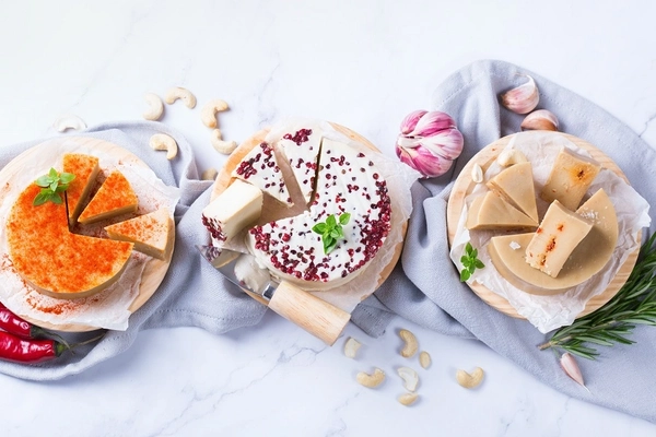 vegan cheese varieties three types of vegan cheese against white background