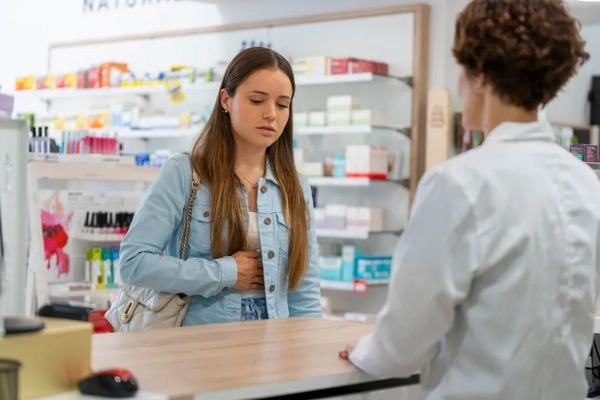 Image Woman with digestive issues in pharmacy
