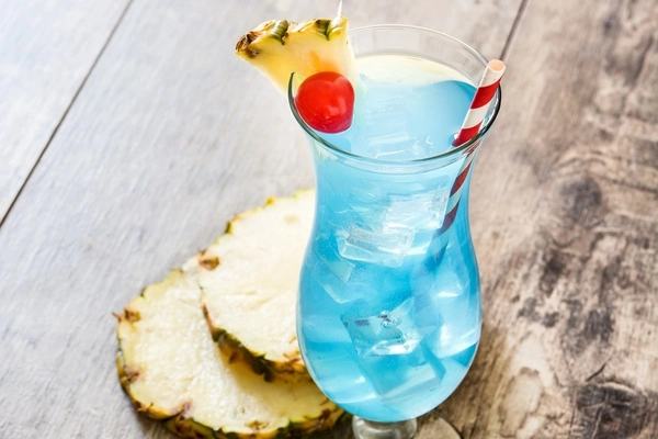 blue drink in glass glass of bright blue drink on wooden table