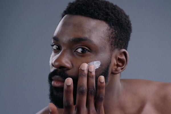 Image Man applies cream to face