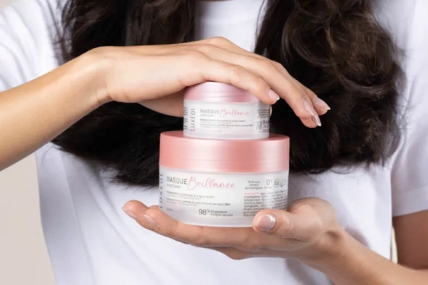 Amcor Luxeol curly hair mask A person holding two jars of cream