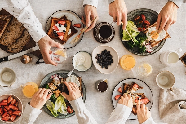 Image Family or friends having breakfast or brunch together, top view