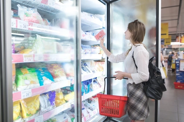 Image Woman shops for frozen food.