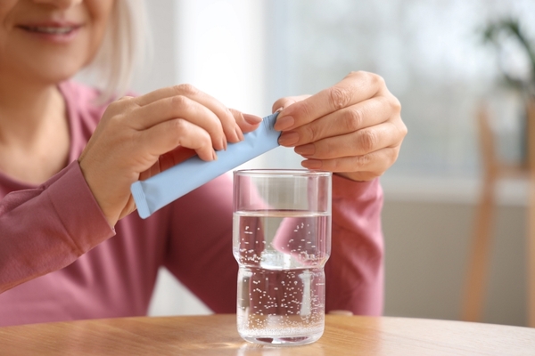 Vegan marine collagen Person taking collagen sachet.