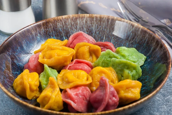 Colorful Chinese dumplings in an earthenware bowl in China. Colorful Chinese dumplings in an earthenware bowl in China.
