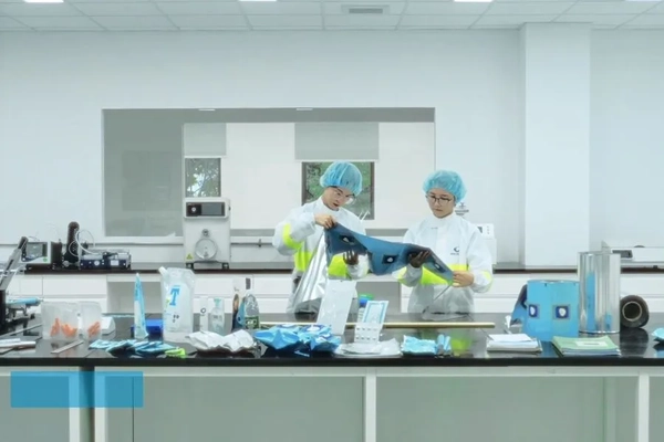 Image Two people in white coats and blue hair caps
