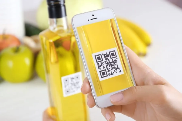 A hand holding a phone scanning a qr code
