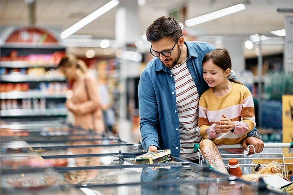 Image Happy father and daughter buying food in supermarket.