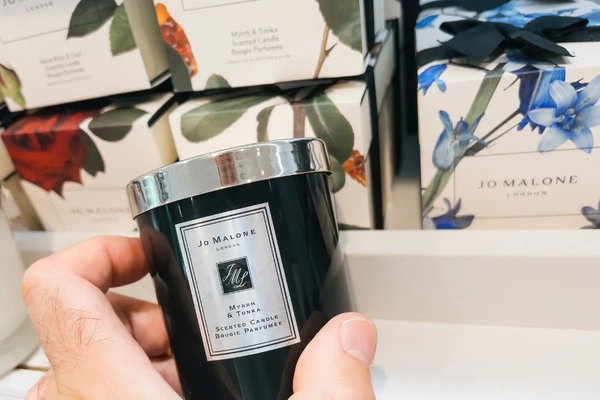 Image Jo Malone candle being held in-store