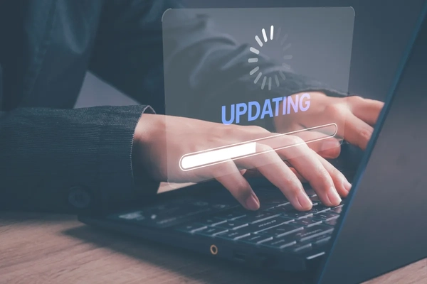 A person typing on a computer that is updating