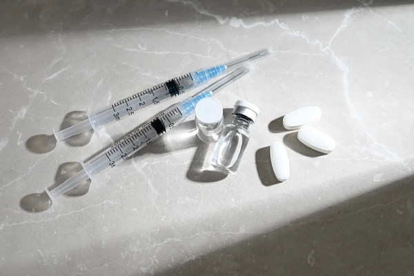 Glass Vials Peptide Compounds and Single Use Syringes Next to Weight Loss Pills